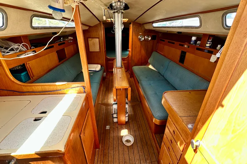 Slide: The Image of Interior of 1983 Sirena 38 sailboat with wooden furnishings and blue seating. - 2