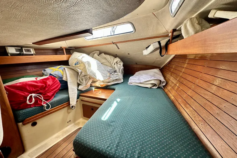 Slide: The Image of Cozy cabin interior of 1983 Sirena 38 sailboat with wooden paneling and storage. - 20