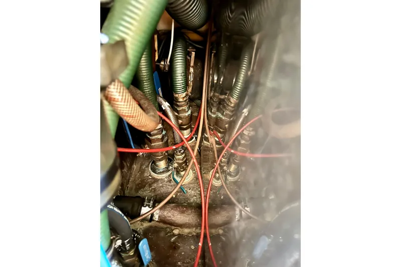 Slide: The Image of Engine compartment of a 1983 Sirena 38 with visible hoses and wiring. - 21