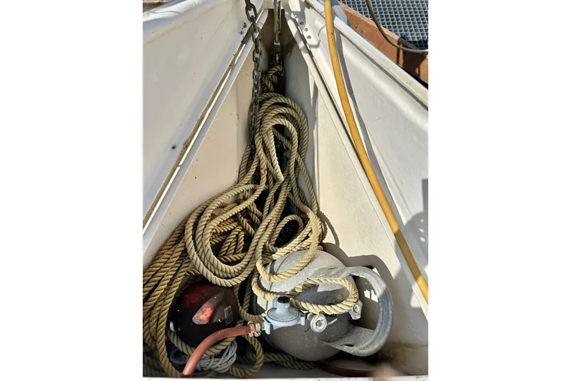 Slide: The Image of Coiled ropes and equipment on 1983 Sirena 38 boat deck. - 23