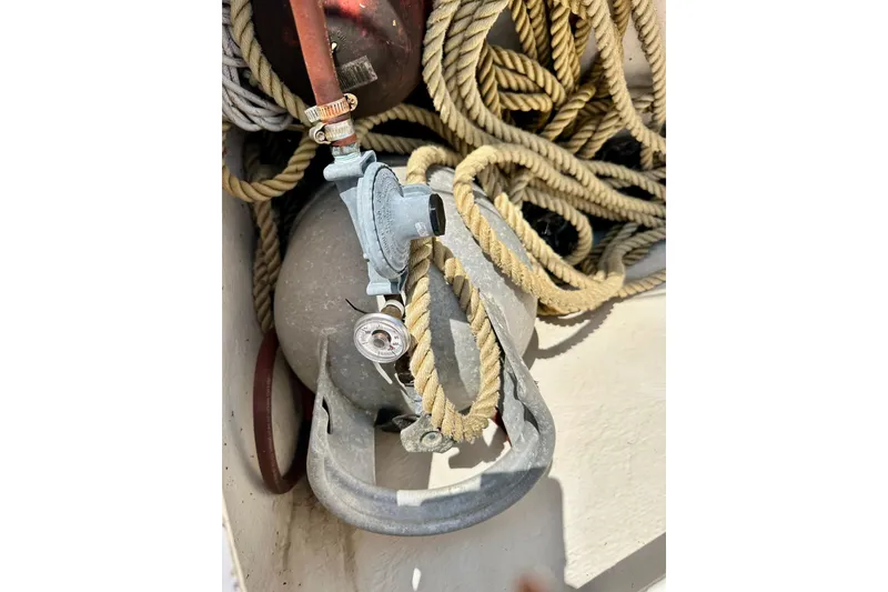 Slide: The Image of Coiled rope and metal valve on 1983 Sirena 38 boat deck. - 24