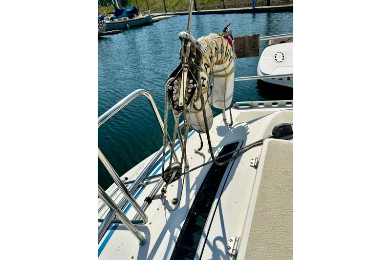 Slide: The Image of Sailboat deck of 1983 Sirena 38, featuring rigging and ropes at marina. - 35