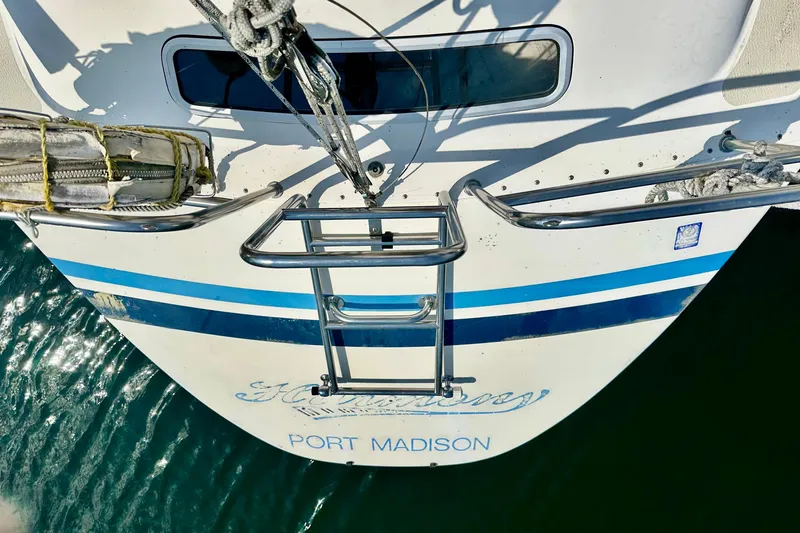 Slide: The Image of Aerial view of 1983 Sirena 38 sailboat stern with ladder, docked at Port Madison. - 36
