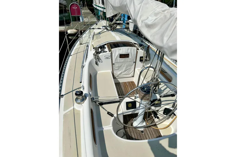 Slide: The Image of 1983 Sirena 38 sailboat deck with steering wheel and rigging. - 37