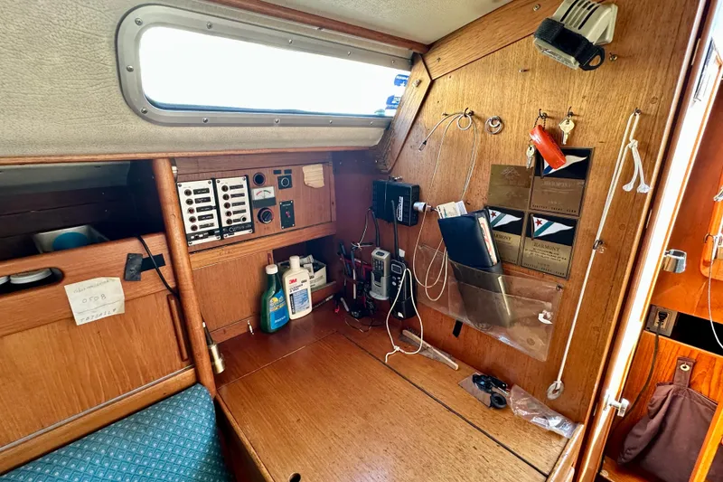 Slide: The Image of 1983 Sirena 38 yacht interior with navigation equipment and storage. - 7