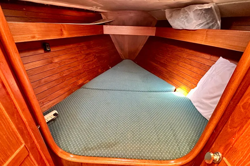 Slide: The Image of Cozy cabin interior of 1983 Sirena 38 sailboat with wooden paneling and comfortable bedding. - 9