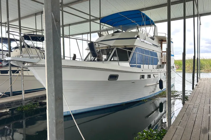 The Image of 1988 CHB Ponderosa Motor Yacht docked under a covered marina. - 0