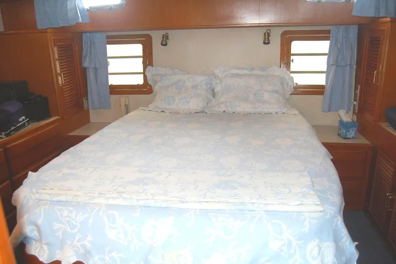 Slide: The Image of Master Stateroom queen walk around berth, bedside storage. - 17
