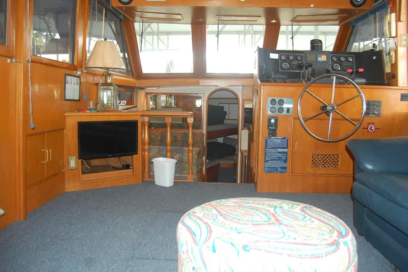 Slide: The Image of Salon interior with helm, seating, and wooden cabinetry, looking forward. - 2