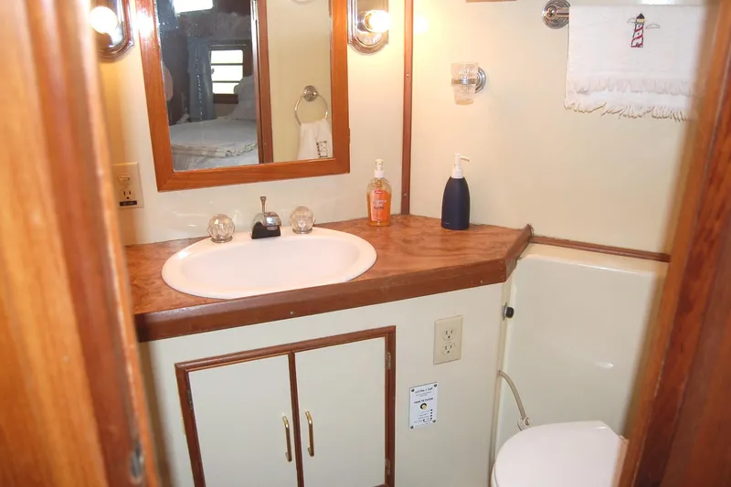 Slide: The Image of Master Stateroom with sink, mirror, large shower and storage. - 20
