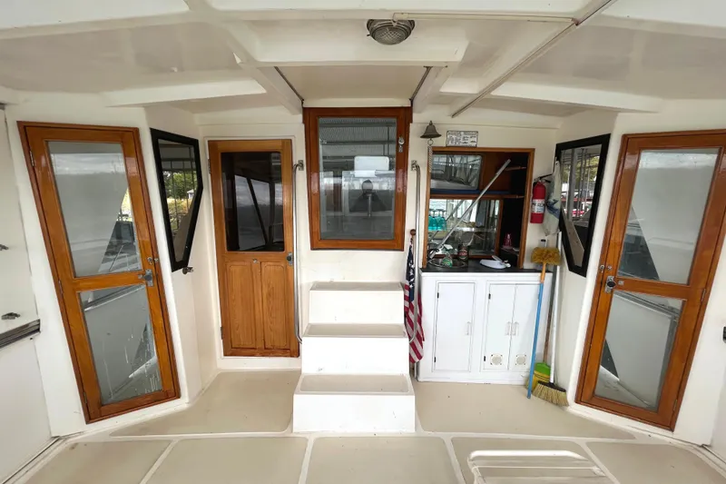 Slide: The Image of 1988 CHB Ponderosa Motor Yacht interior with wooden doors and storage cabinets. - 23