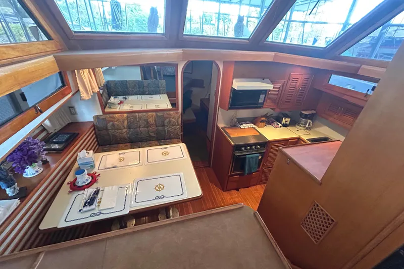 Slide: The Image of Interior of 1988 CHB Ponderosa Motor Yacht with kitchen and dining area. - 3