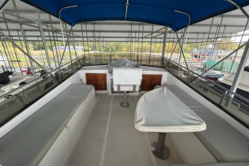 Slide: The Image of 1988 CHB Ponderosa Motor Yacht interior with seating and covered table under blue canopy. - 5
