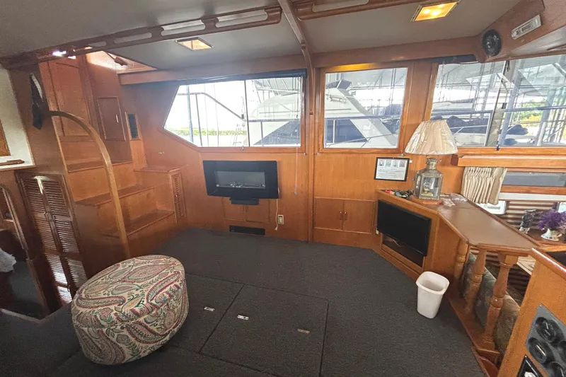 Slide: The Image of Interior of 1988 CHB Ponderosa Motor Yacht with wood paneling and cozy furnishings. - 7