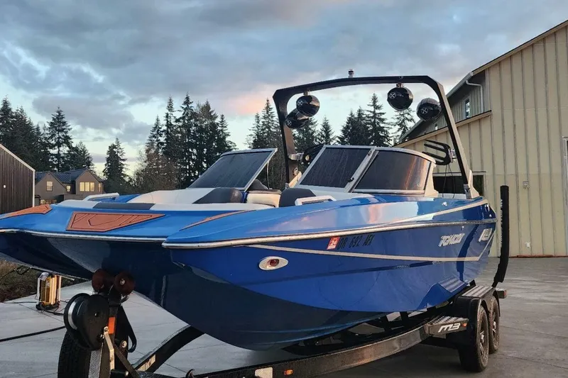 Slide: The Image of Blue 2017 MB F21 boat on trailer, parked outdoors near buildings and trees. - 4