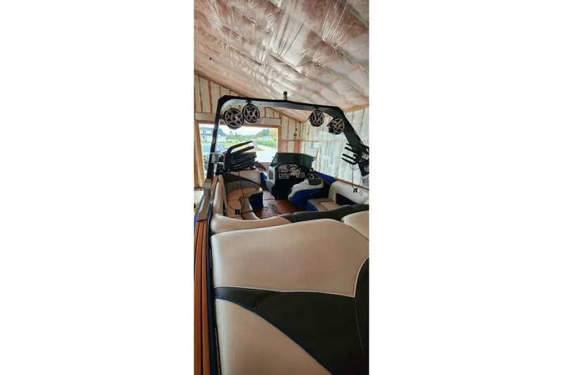 Slide: The Image of 2017 MB F21 boat interior with speakers and seating in a covered storage area. - 7