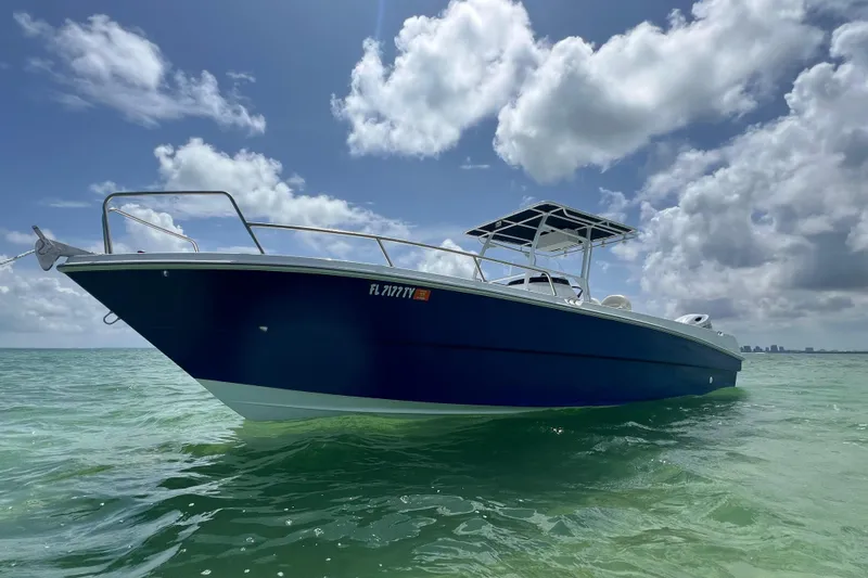 The Image of 2024 Yamane Center Consoles boat on calm ocean under cloudy sky. - 0