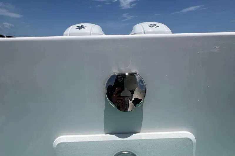 Slide: The Image of 2024 Yamane Center Consoles boat with dual engines, chrome detail, and clear blue sky. - 10