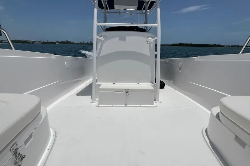 Slide: The Image of 2024 Yamane Center Consoles boat interior on open water, showcasing sleek design and seating. - 8