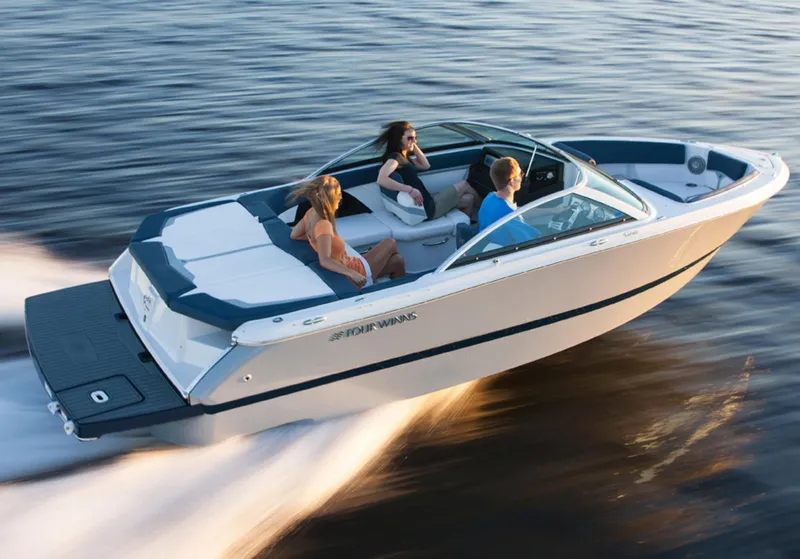 Slide: The Image of 2013 Four Winns H210 boat cruising on water with passengers. - 1