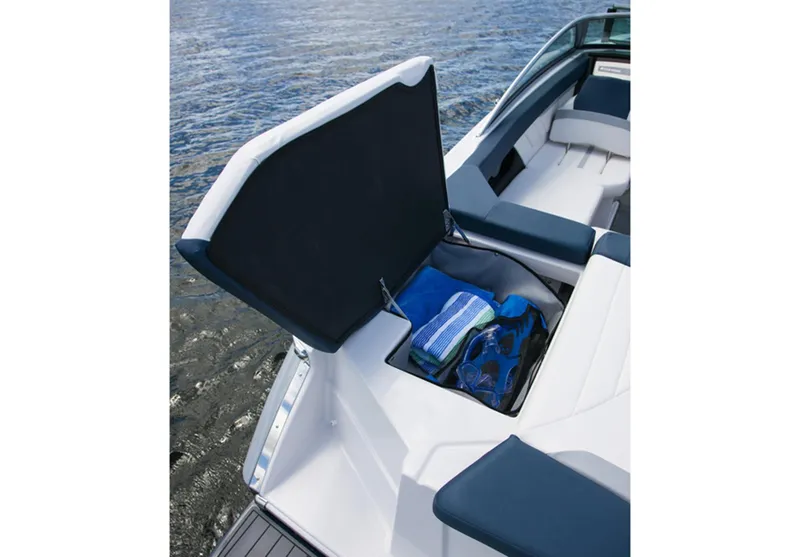 Slide: The Image of 2013 Four Winns H210 boat with open storage compartment and towels. - 7