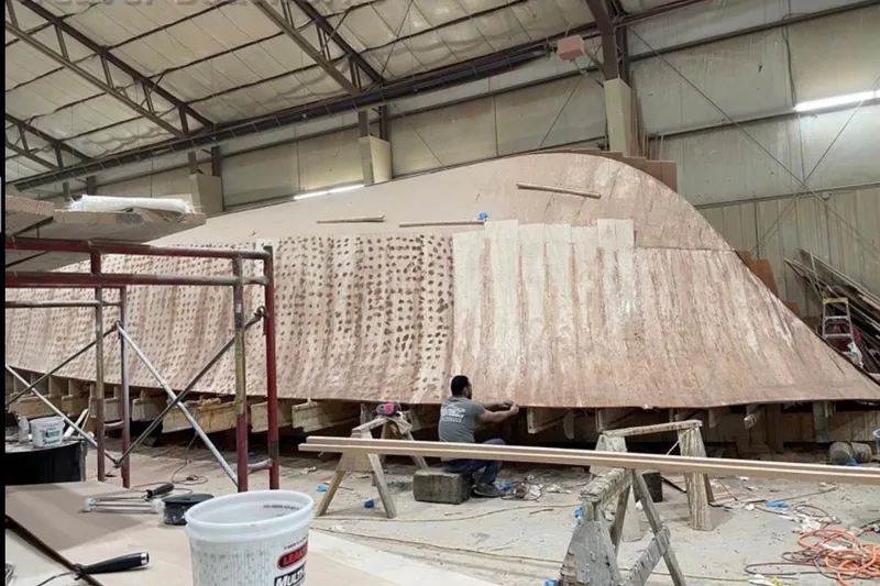 The Image of 2026 Weaver Sportfish boat under construction in a workshop, showcasing craftsmanship. - 1