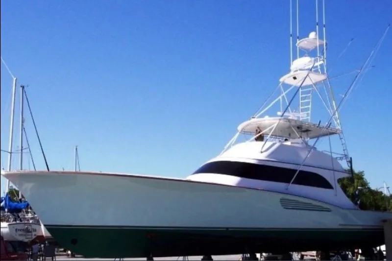 Slide: The Image of 2026 Weaver Sportfish yacht with sleek design and tall tower against clear blue sky. - 4