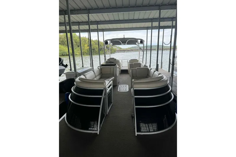 The Image of 2014 Bennington 2875 QCW I/O pontoon boat covered in dock. - 0