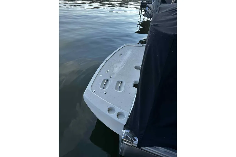 Slide: The Image of 2014 Bennington 2875 QCW I/O boat platform on calm water. - 12