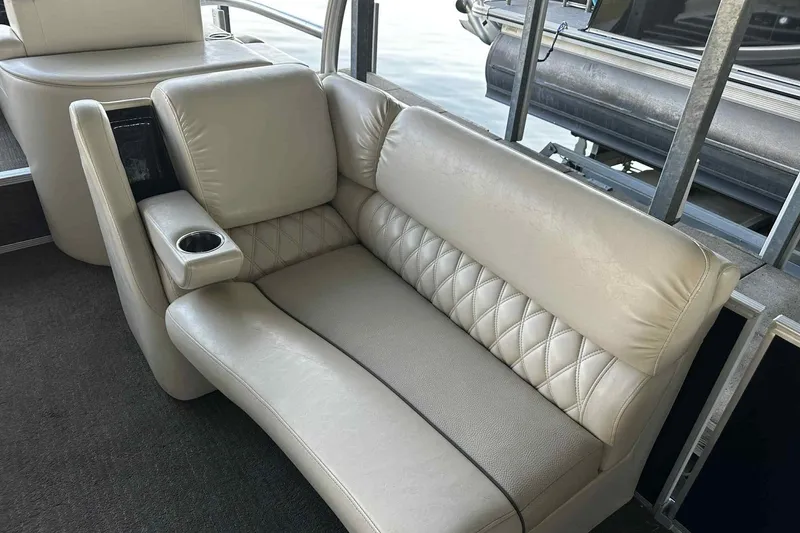 Slide: The Image of Luxurious seating on 2014 Bennington 2875 QCW I/O boat with quilted upholstery and cup holder. - 14
