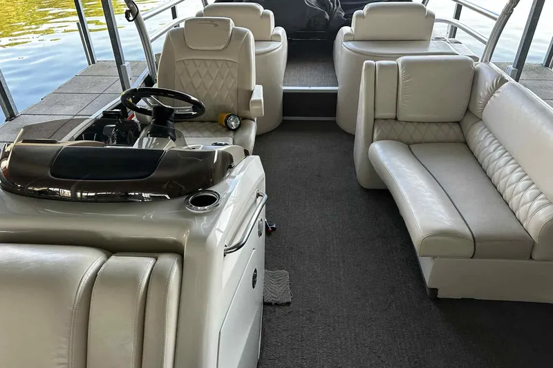 Slide: The Image of 2014 Bennington 2875 QCW I/O boat interior with luxurious seating and steering console. - 16