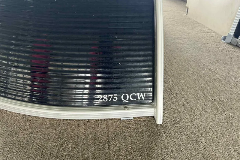 Slide: The Image of 2014 Bennington 2875 QCW I/O pontoon boat interior with plush seating and scenic lake view. - 4