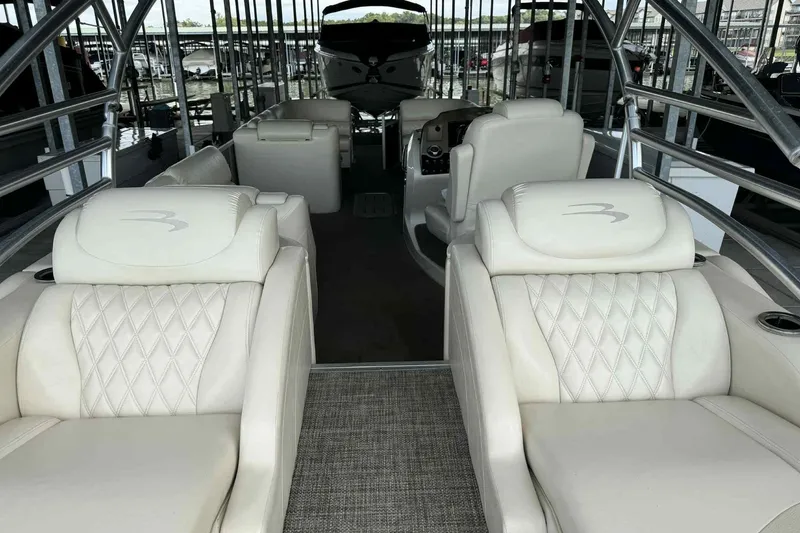 Slide: The Image of 2014 Bennington 2875 QCW I/O boat dashboard with steering wheel and Garmin navigation system. - 6