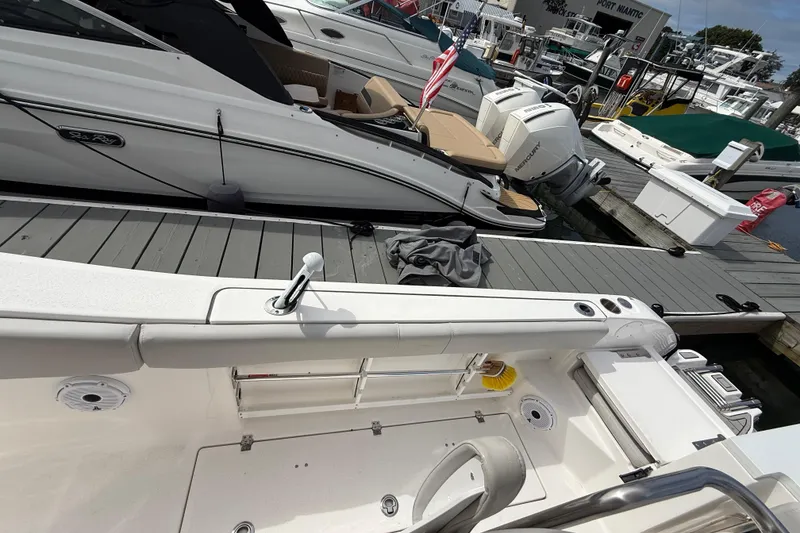 Slide: The Image of 2021 Sea Fox 288 Commander docked alongside other boats at a marina. - 14