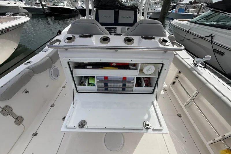 Slide: The Image of 2021 Sea Fox 288 Commander boat interior with open storage compartment and Garmin displays. - 18
