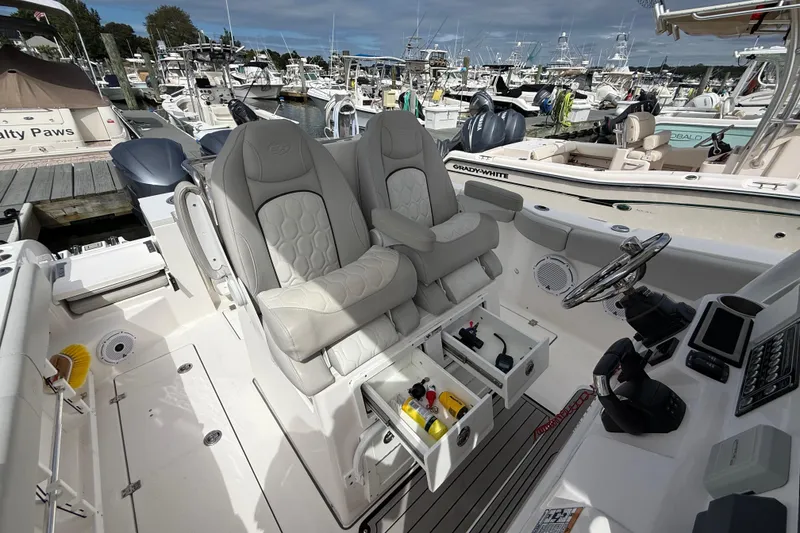 Slide: The Image of 2021 Sea Fox 288 Commander boat interior with dual captain's chairs and control panel. - 19