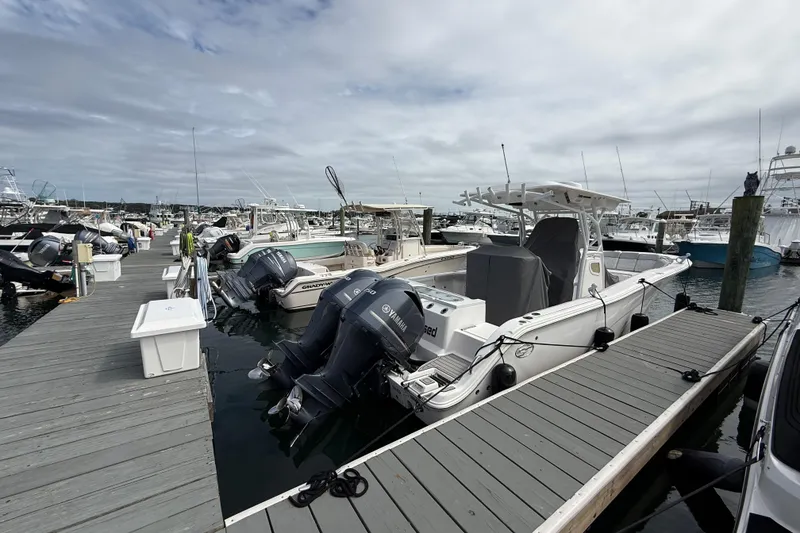 Slide: The Image of 2021 Sea Fox 288 Commander docked at a marina with other boats. - 2