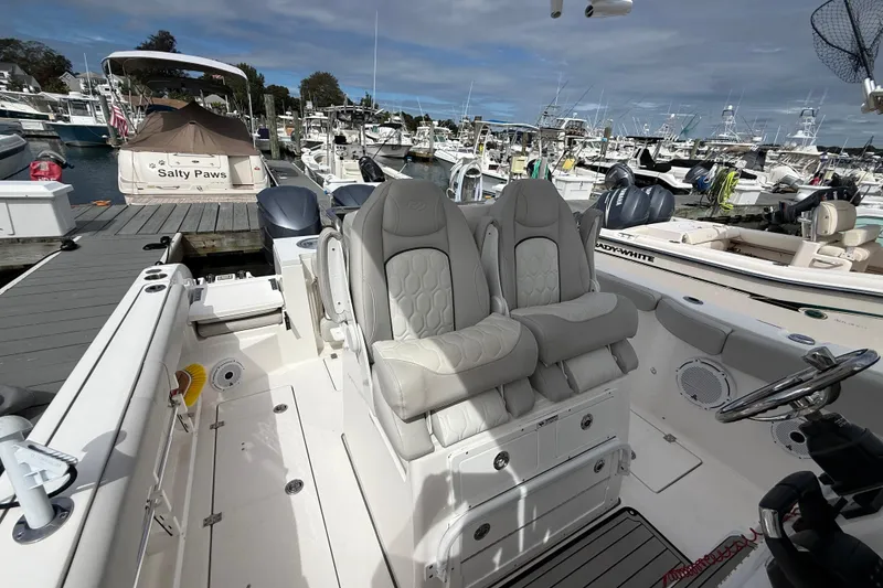 Slide: The Image of 2021 Sea Fox 288 Commander boat interior with plush seating at a marina. - 20