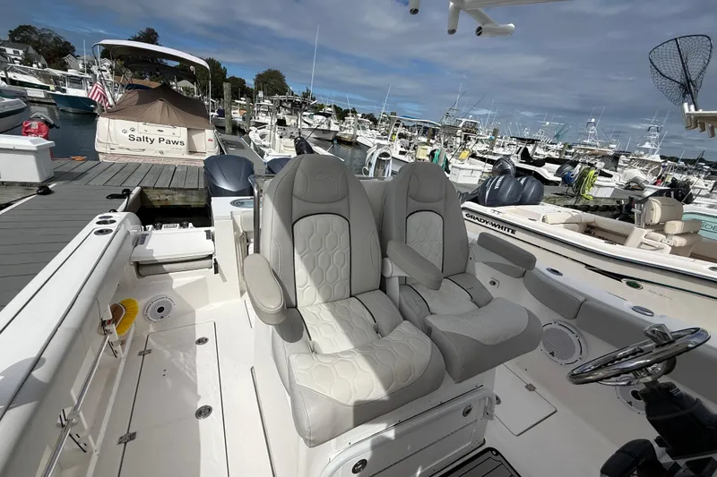 Slide: The Image of 2021 Sea Fox 288 Commander boat interior with dual captain's chairs at marina. - 22