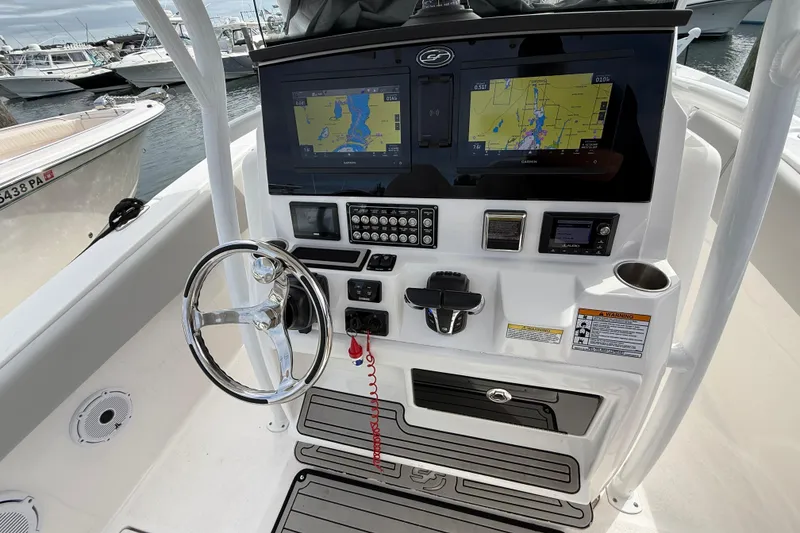 Slide: The Image of 2021 Sea Fox 288 Commander boat dashboard with navigation screens and steering wheel. - 23