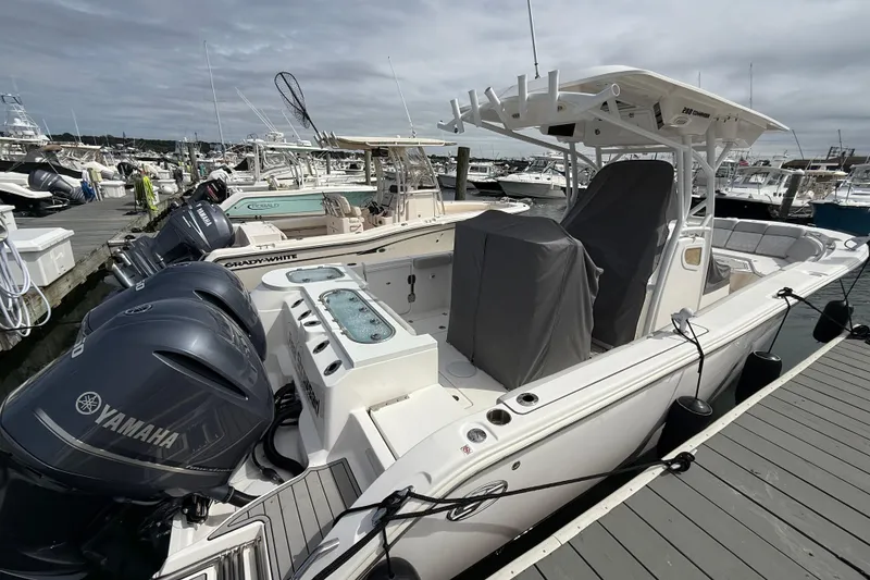 Slide: The Image of 2021 Sea Fox 288 Commander boat docked with Yamaha engines, marina background. - 3