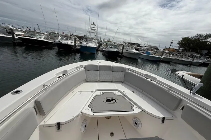 Slide: The Image of 2021 Sea Fox 288 Commander boat docked in a marina with other vessels. - 32