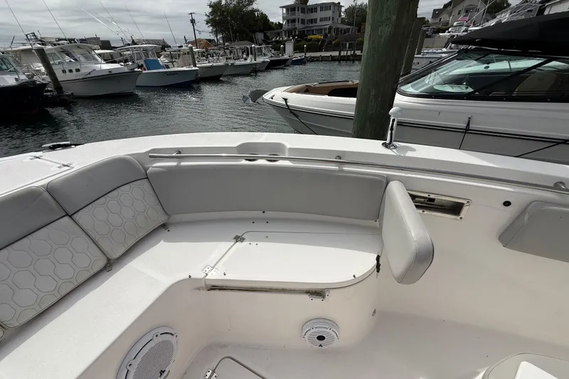 Slide: The Image of 2021 Sea Fox 288 Commander boat interior with cushioned seating at a marina. - 33