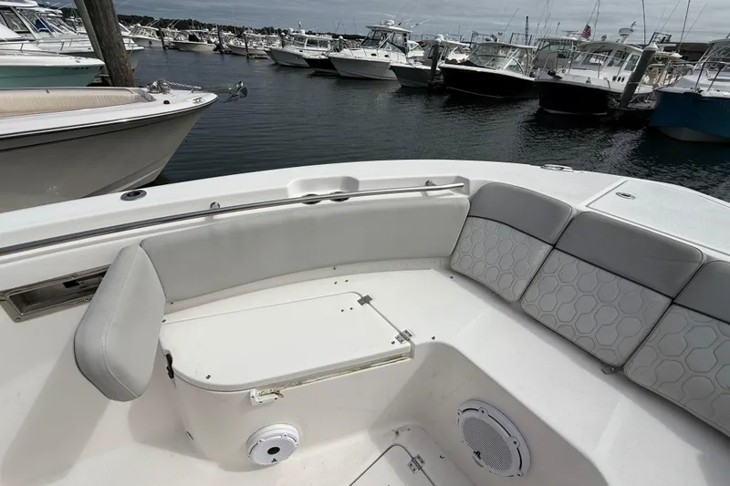 Slide: The Image of 2021 Sea Fox 288 Commander boat interior with cushioned seating at marina. - 34