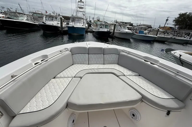 Slide: The Image of 2021 Sea Fox 288 Commander boat with spacious seating at a marina. - 36