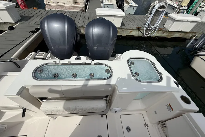 Slide: The Image of 2021 Sea Fox 288 Commander boat with dual engines and live wells at a marina dock. - 9