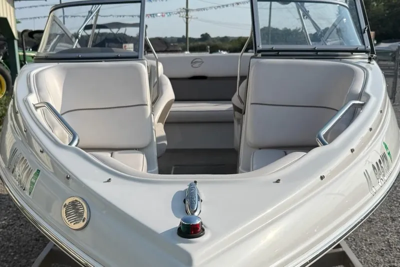 Slide: The Image of 2012 195 SS boat with white seating and sleek design, docked outdoors. - 3