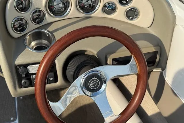 Slide: The Image of Steering wheel and dashboard of 2012 195 SS boat with gauges and controls. - 8