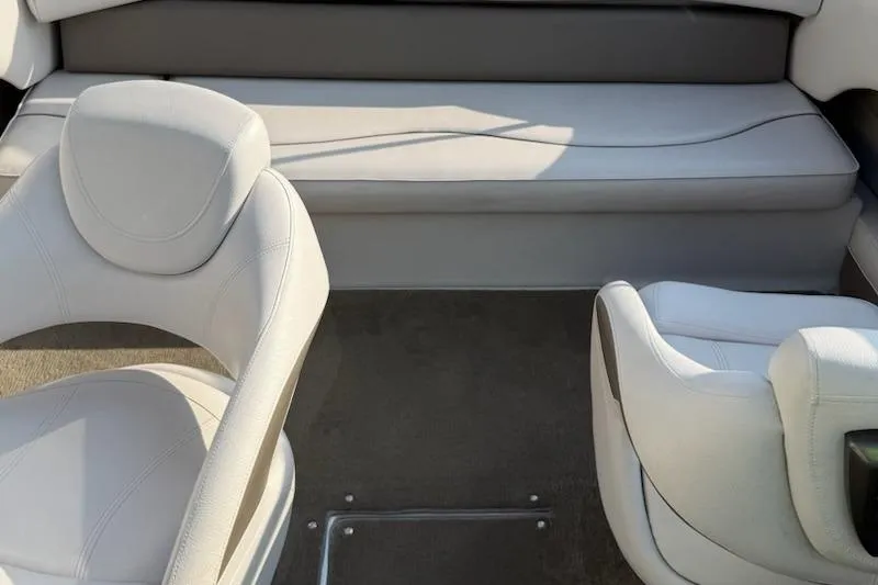 Slide: The Image of Interior of a 2012 195 SS boat with white seating and carpeted floor. - 9