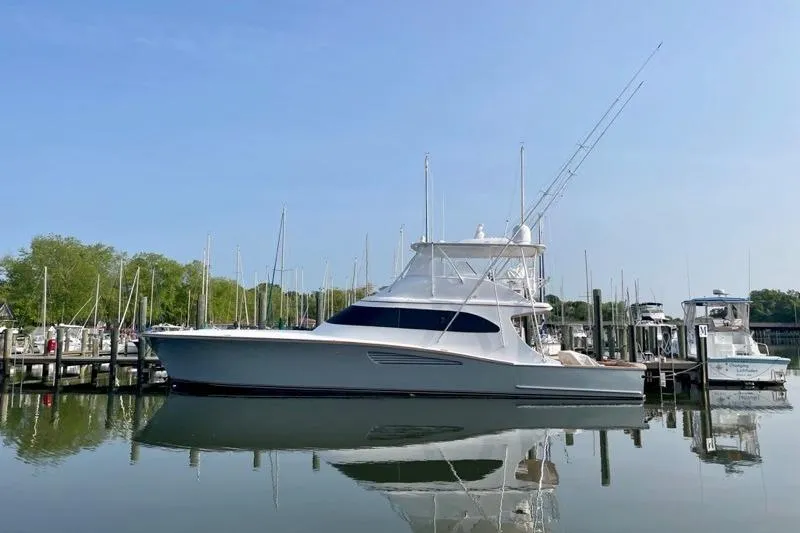 The Image of 2025 Weaver Sportfish yacht docked at marina, reflecting on calm water. - 0